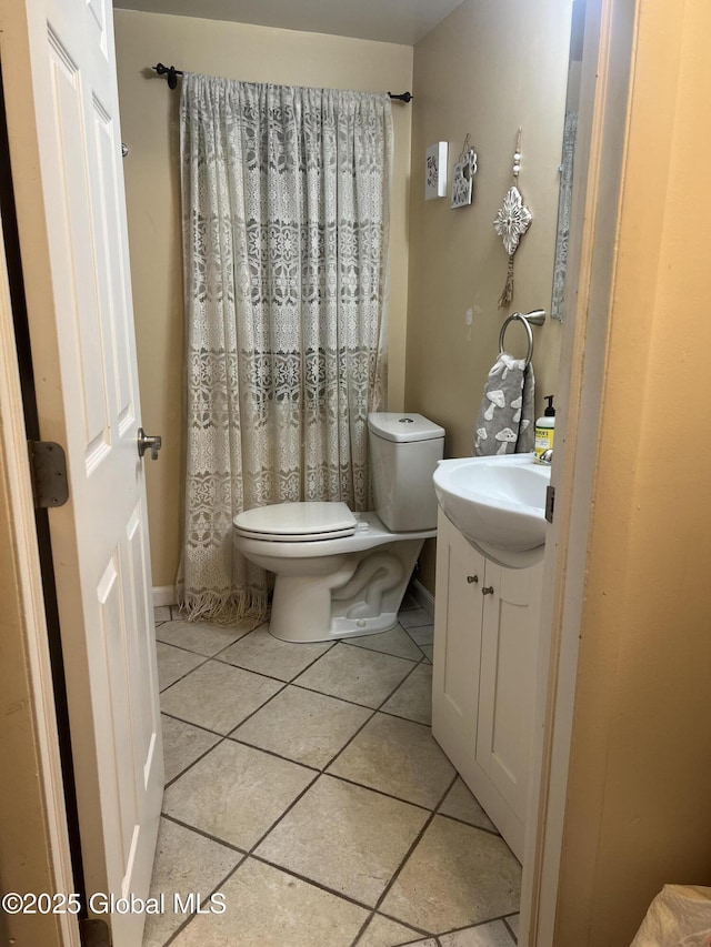 bathroom featuring vanity, tile patterned floors, and toilet