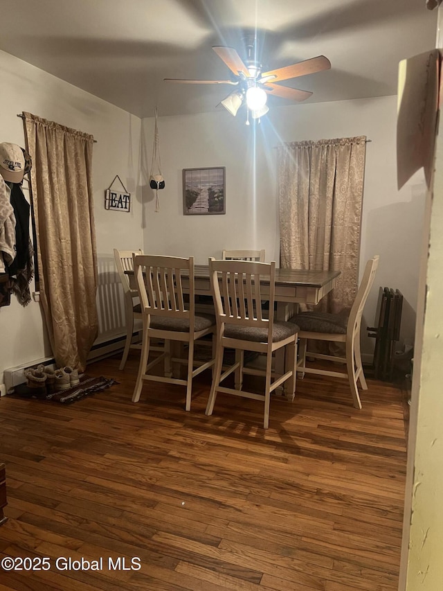 dining area featuring dark hardwood / wood-style flooring and ceiling fan