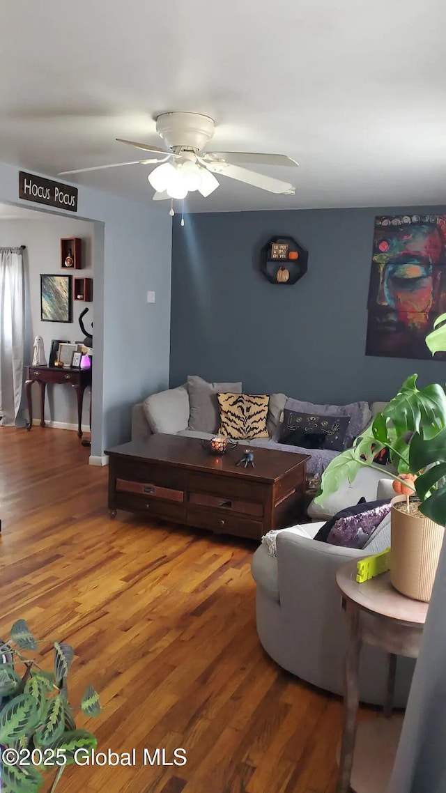 living room with hardwood / wood-style flooring and ceiling fan