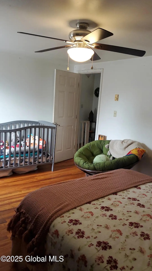 bedroom with hardwood / wood-style floors and ceiling fan