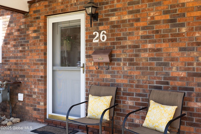 property entrance with brick siding