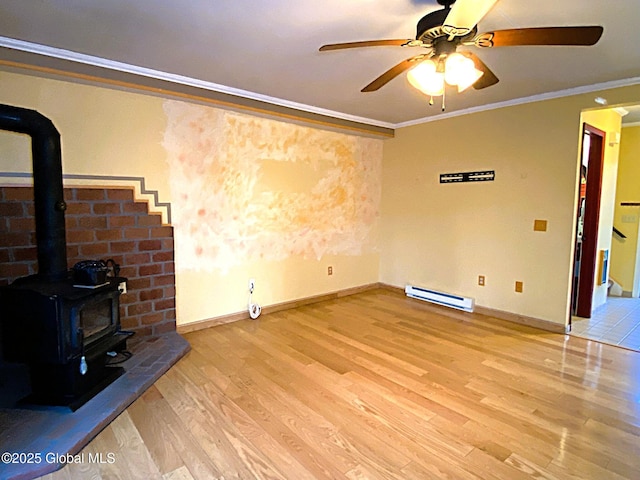 unfurnished living room with a wood stove, light wood finished floors, ceiling fan, crown molding, and a baseboard radiator