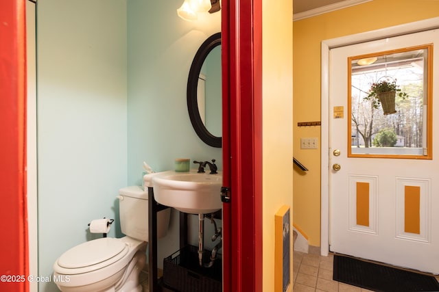 bathroom featuring tile patterned floors, toilet, and ornamental molding