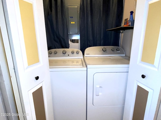 clothes washing area featuring washing machine and clothes dryer, electric panel, and laundry area