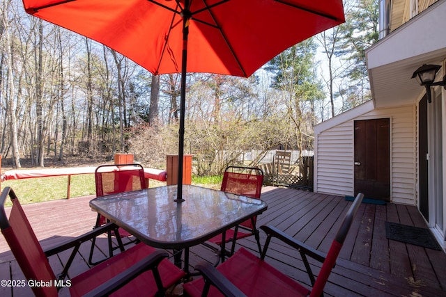 wooden terrace featuring outdoor dining area