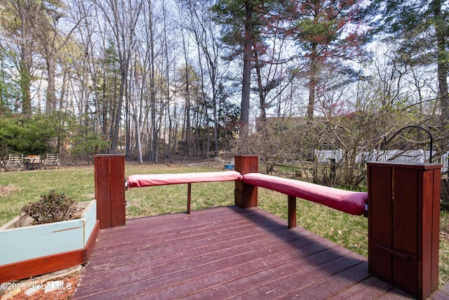 wooden terrace with a lawn