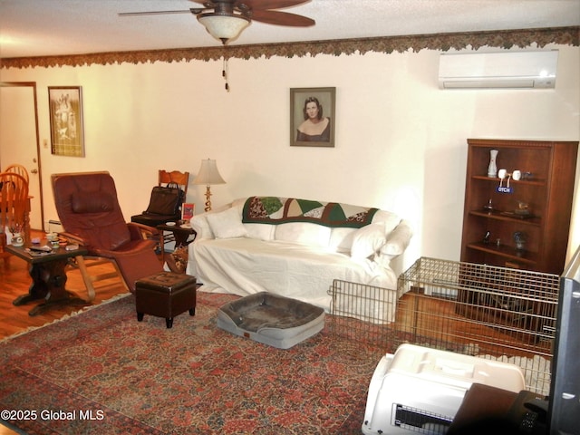 living room with wood-type flooring, a baseboard radiator, a wall mounted AC, ceiling fan, and a textured ceiling