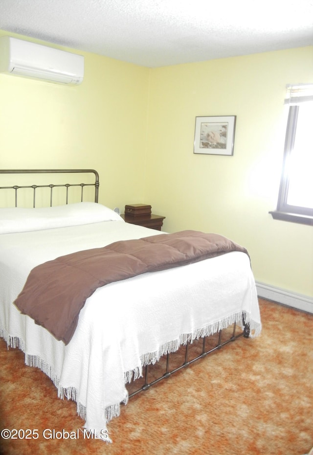 bedroom featuring a wall mounted AC, carpet, and a baseboard heating unit