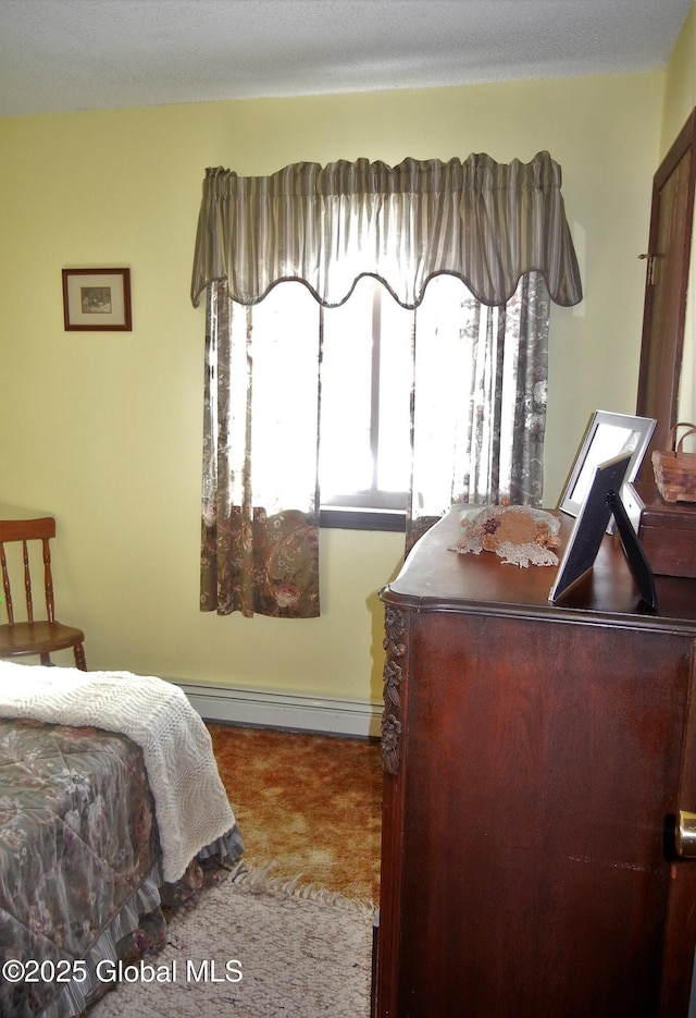 bedroom with a baseboard heating unit