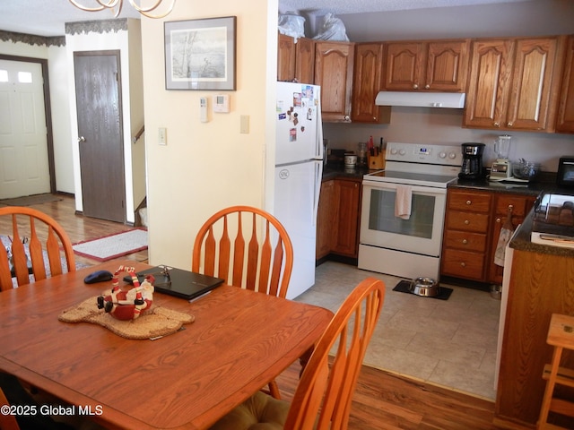 kitchen with white appliances and light hardwood / wood-style floors