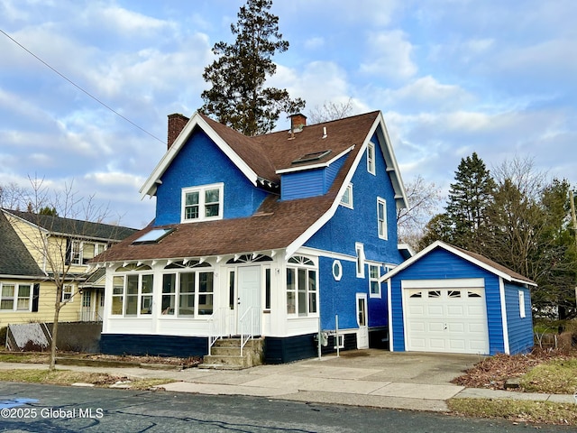 view of front of home featuring a garage and an outdoor structure