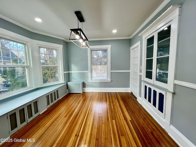 unfurnished sunroom with a healthy amount of sunlight and radiator