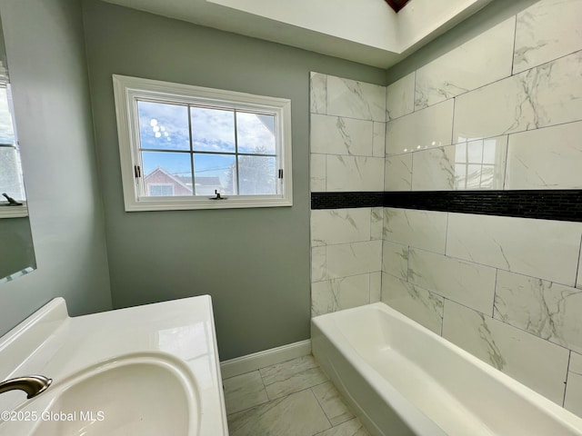 bathroom featuring sink and tiled shower / bath