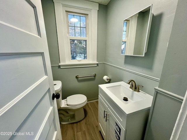 bathroom featuring vanity, hardwood / wood-style floors, and toilet