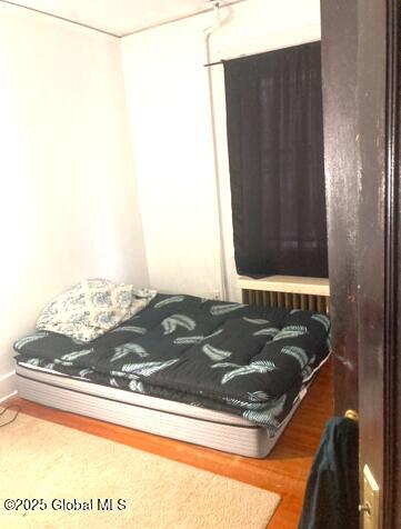 bedroom with wood-type flooring