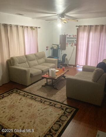 living room with hardwood / wood-style floors and ceiling fan