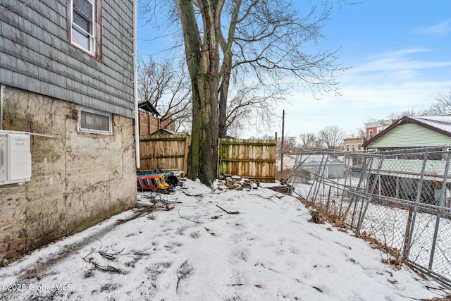 view of yard layered in snow