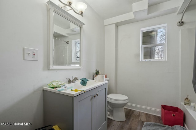 bathroom featuring walk in shower, vanity, toilet, and hardwood / wood-style floors