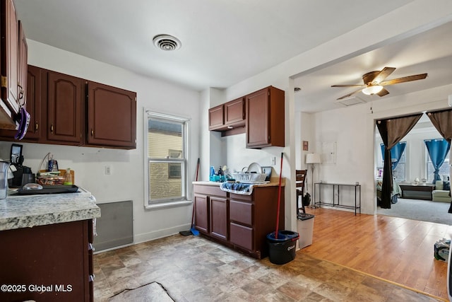 kitchen with dark brown cabinets and ceiling fan