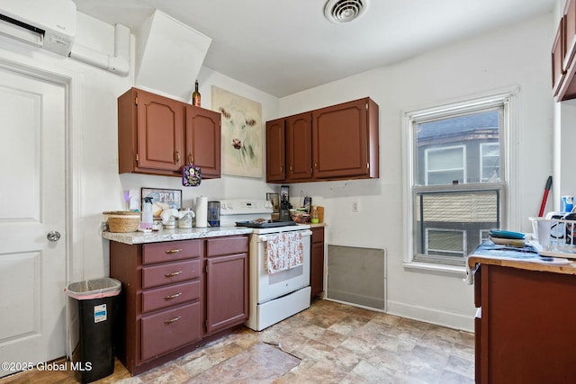 kitchen with white electric stove and an AC wall unit