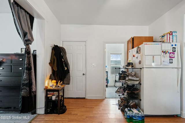 kitchen with white fridge and light hardwood / wood-style flooring