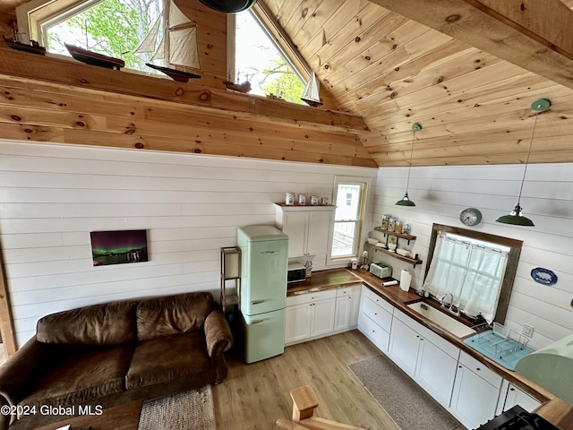 kitchen with wood counters, decorative light fixtures, sink, white cabinets, and wooden ceiling