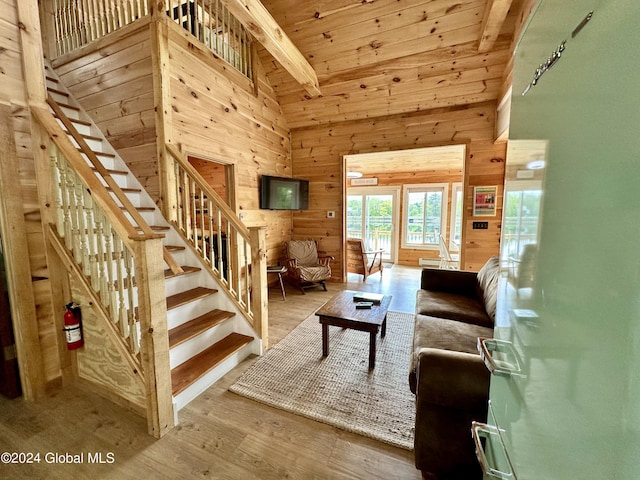 living room featuring hardwood / wood-style flooring, wooden walls, high vaulted ceiling, and wooden ceiling