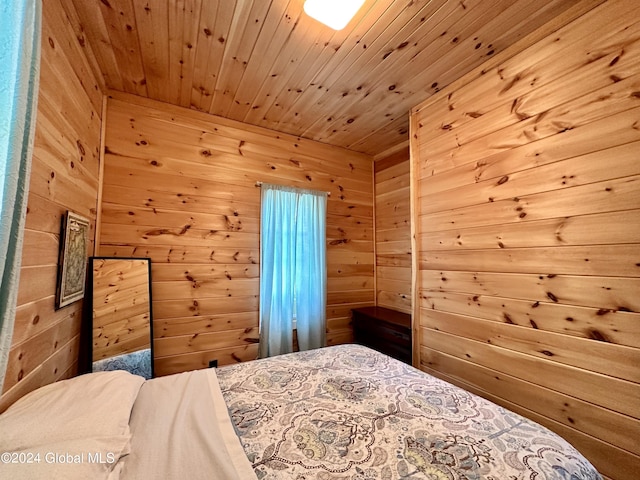 bedroom featuring wooden walls and wooden ceiling