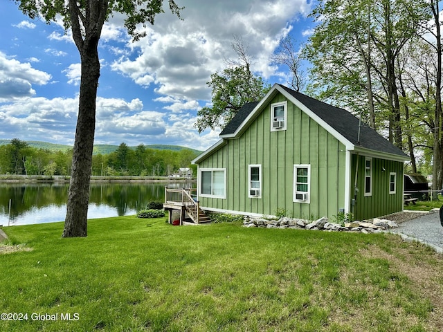 exterior space featuring a water view and a yard