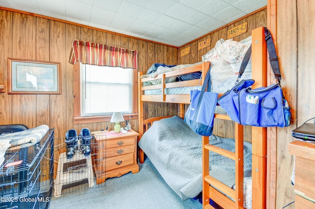 carpeted bedroom with wood walls