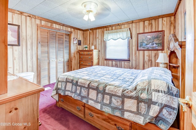 carpeted bedroom with wooden walls and a closet