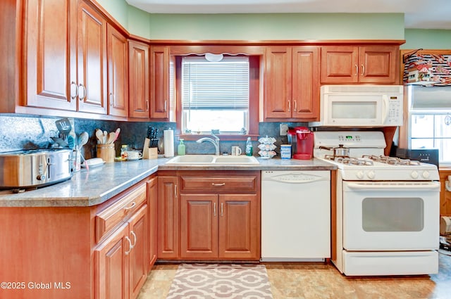 kitchen featuring tasteful backsplash, sink, and white appliances