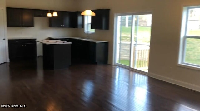 kitchen featuring plenty of natural light and dark hardwood / wood-style floors