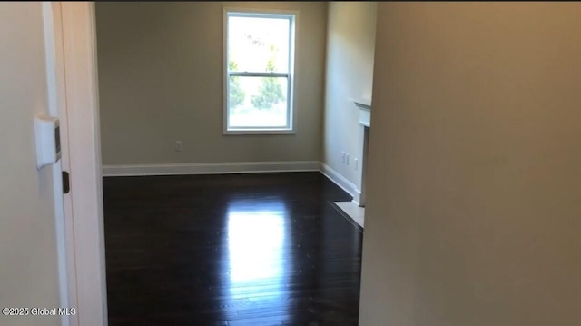 empty room featuring dark wood-type flooring