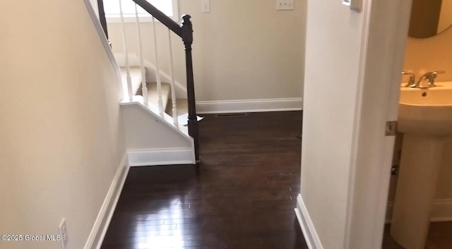 stairway featuring wood-type flooring