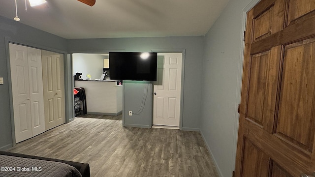 bedroom featuring ceiling fan, a closet, and light hardwood / wood-style flooring