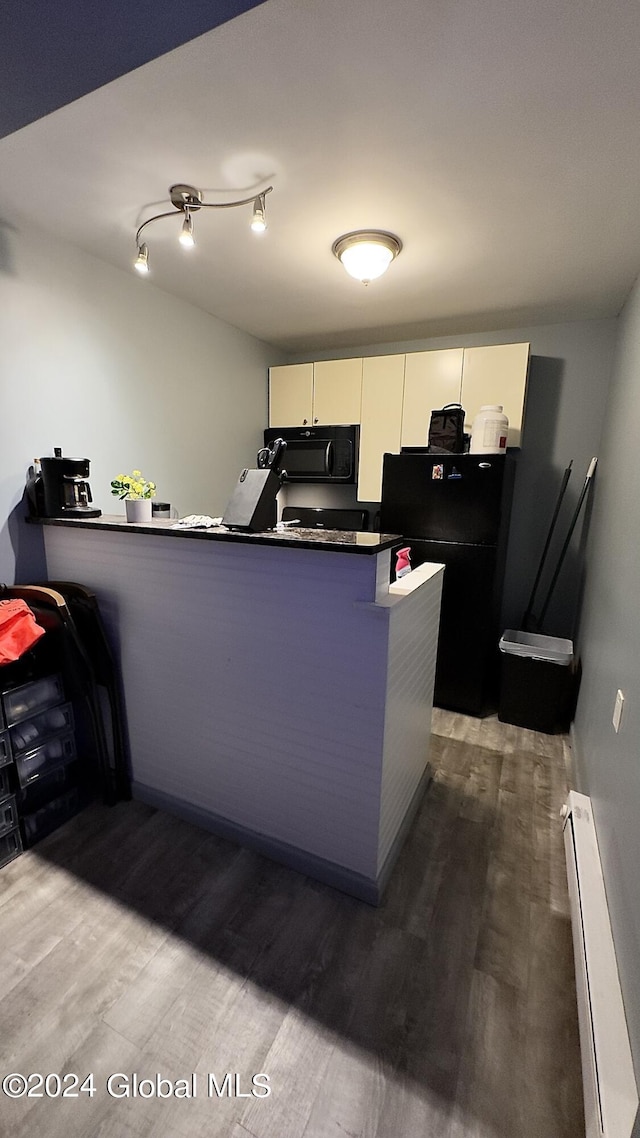 kitchen with white cabinetry, dark hardwood / wood-style floors, baseboard heating, and black appliances