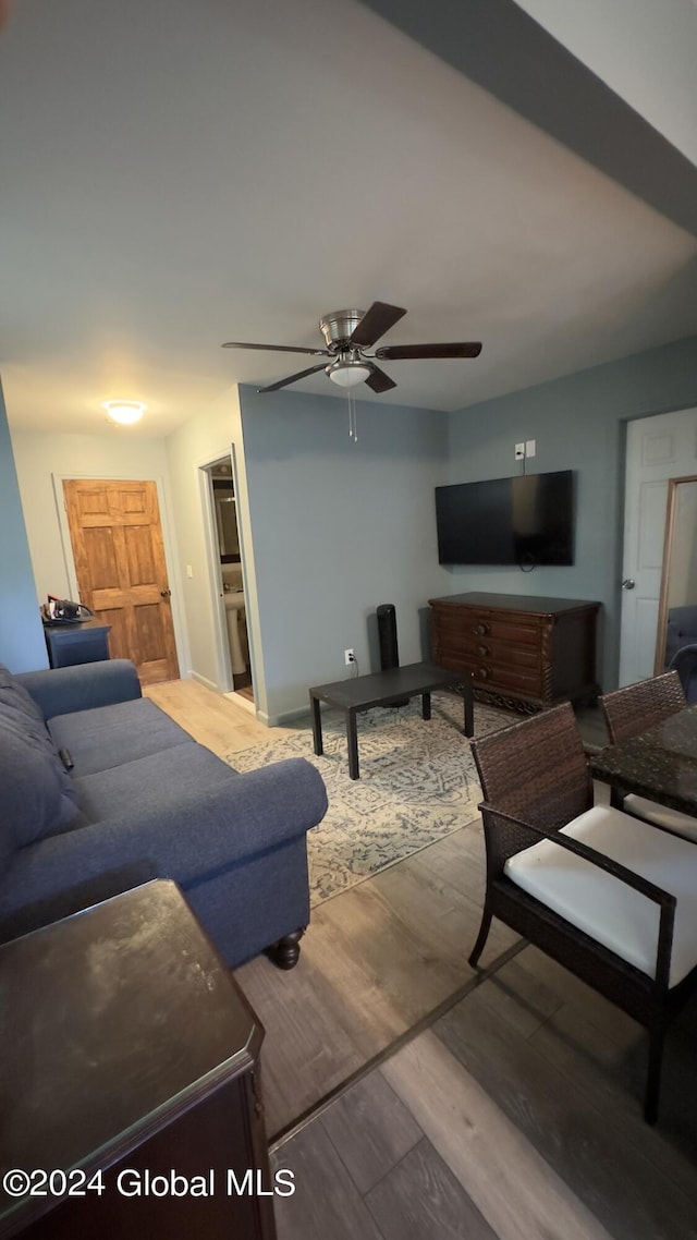 living room featuring ceiling fan and hardwood / wood-style floors