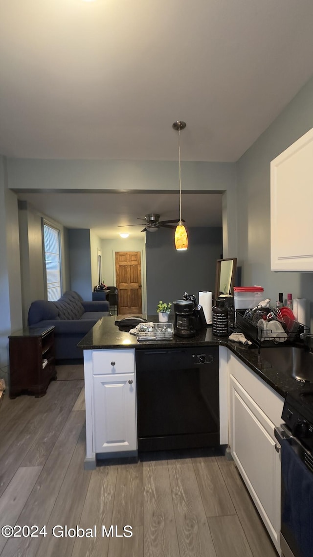 kitchen featuring pendant lighting, light hardwood / wood-style flooring, white cabinetry, black appliances, and kitchen peninsula