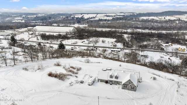 snowy aerial view featuring a mountain view