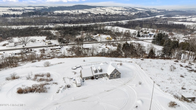 snowy aerial view featuring a mountain view