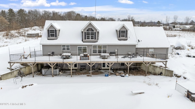 snow covered house with a deck