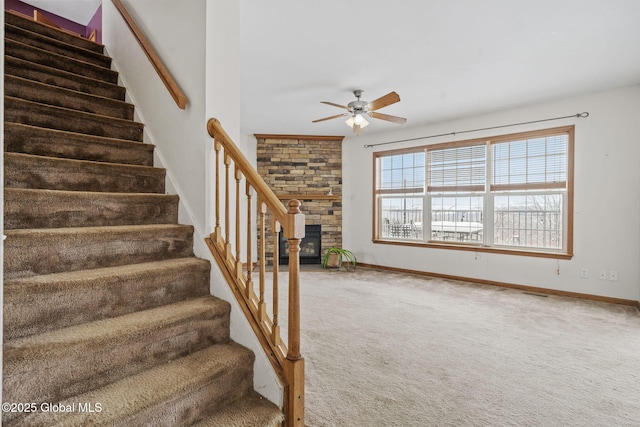 stairs with carpet floors and ceiling fan