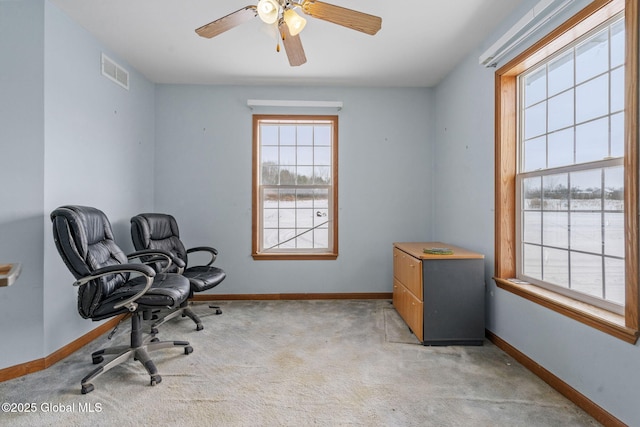 carpeted home office featuring ceiling fan