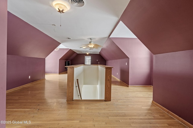 additional living space with ceiling fan, lofted ceiling, and light hardwood / wood-style floors