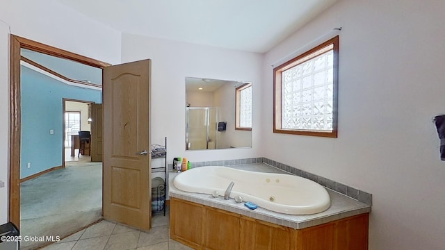 bathroom with tile patterned flooring, a wealth of natural light, and separate shower and tub