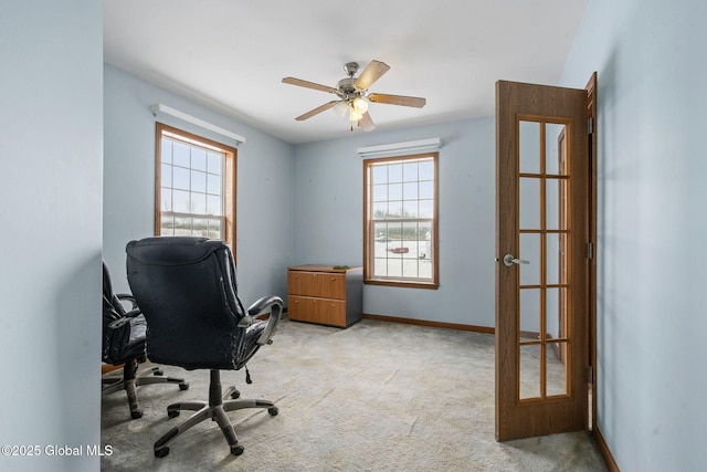 carpeted office featuring ceiling fan