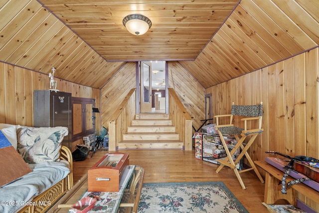 interior space featuring hardwood / wood-style flooring, vaulted ceiling, wood ceiling, and wood walls