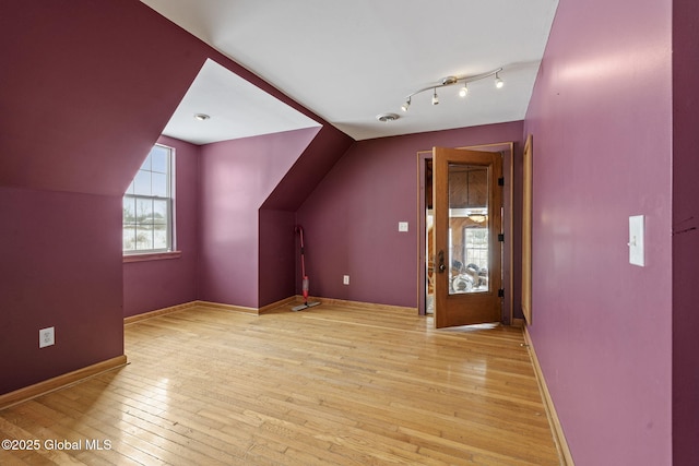 bonus room featuring lofted ceiling and light wood-type flooring