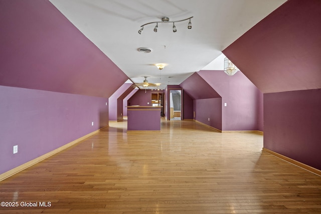 bonus room featuring vaulted ceiling and light hardwood / wood-style flooring